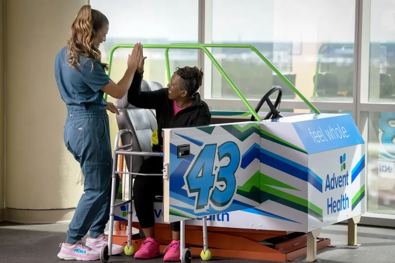A female patient hi-fiving her healthcare provider