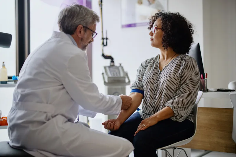 A Doctor Prepares His Patient's Arm for a Blood Draw.