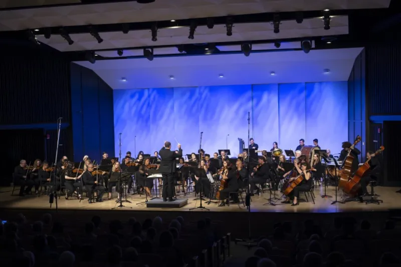 AdventHealth Orchestra performing on an indoor stage.