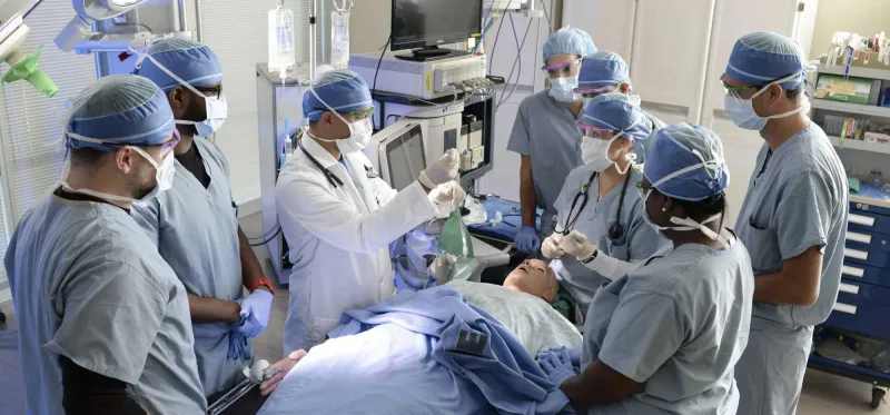 A group of surgical trainees conducting a mock surgery