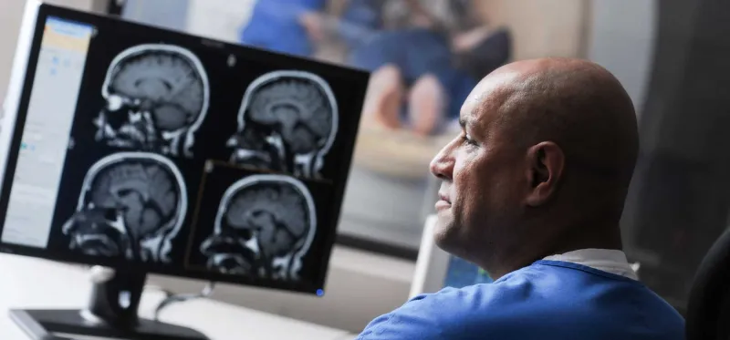 A nurse technician in front of a computer