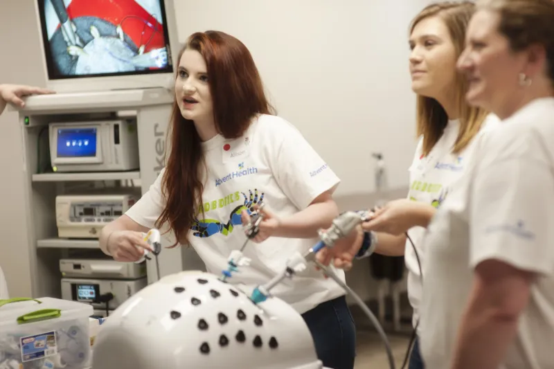 A group of people learning about Robotic Surgery.