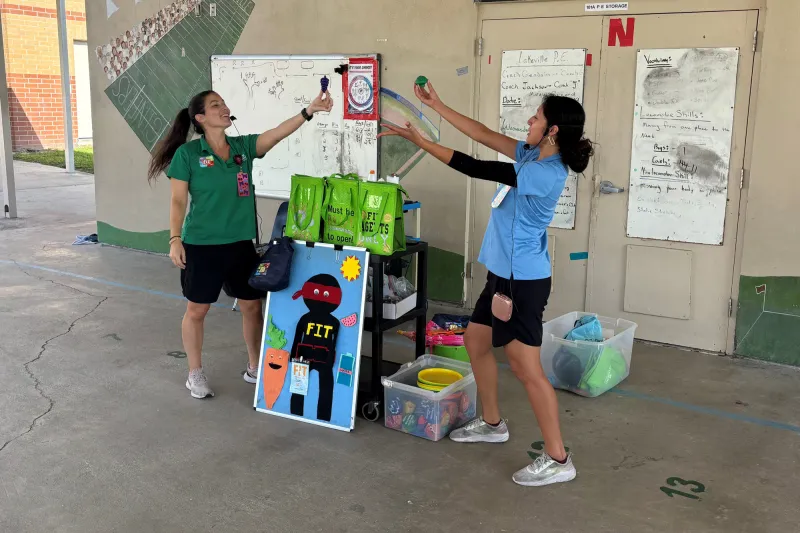 Two women perform a demonstration for the Mission Fit program.