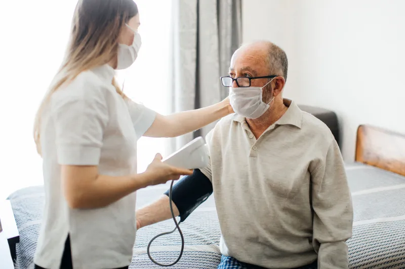 A man getting his blood pressure checked at the doctor. 