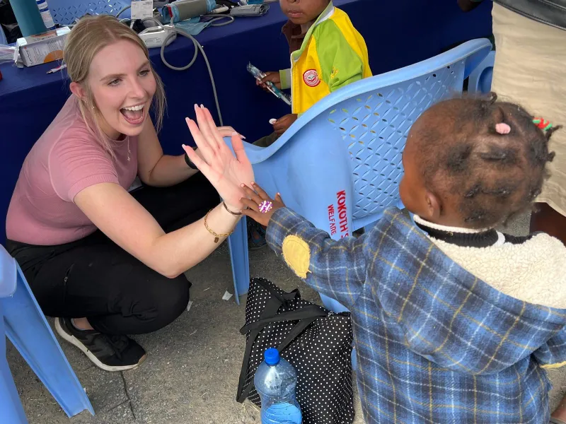 woman-high-five-young-child
