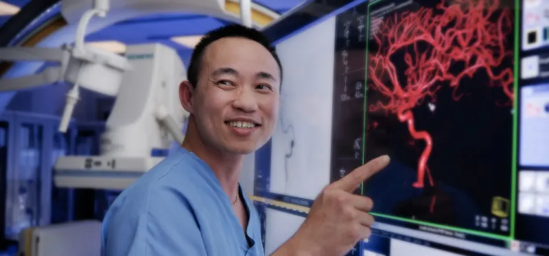 A nurse pointing his finger on the medical screen