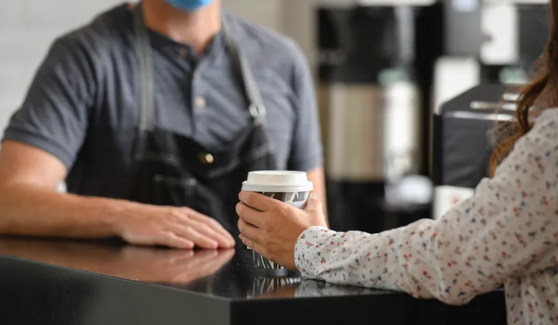 Barista serving coffee