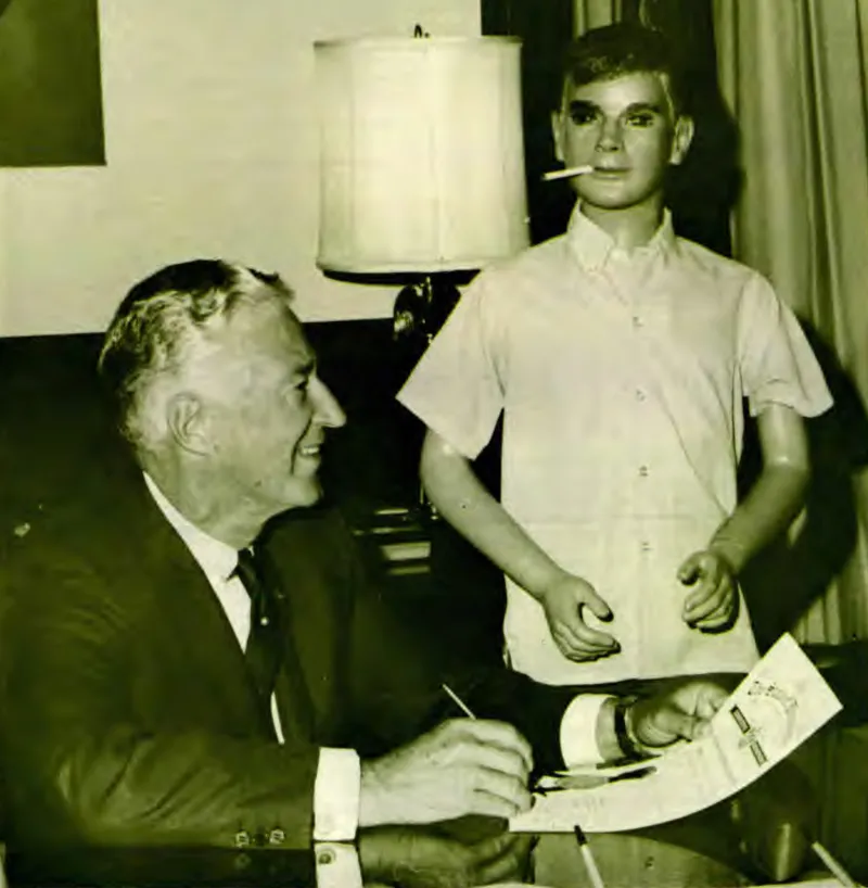 Smoking Sam looks over the shoulder of Wisconsin Governor Warren P. Knowles, who signs a proclamation designating the week of October 12 through 18 Stop Smoking Week in Wisconsin