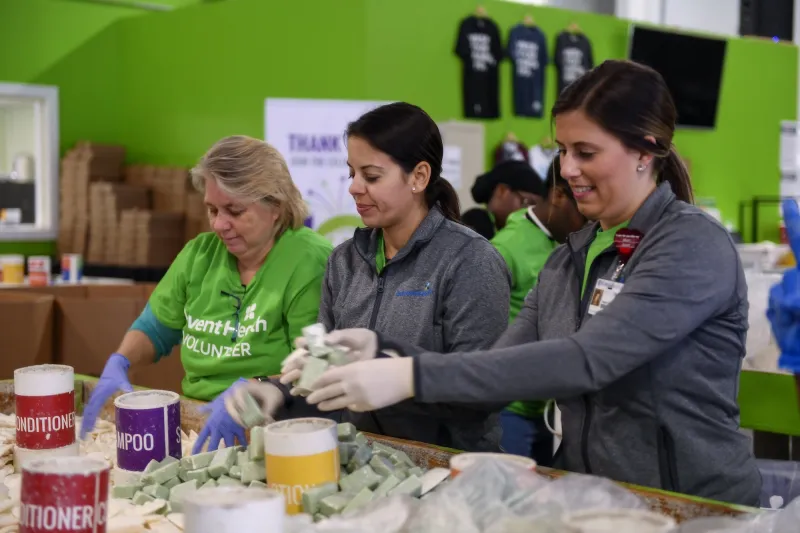 AdventHealth employees and volunteers working with bar soaps and conditioners