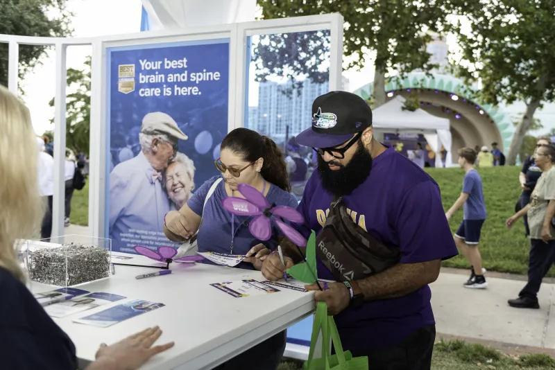 Participants write on paper at Walk to End Alzheimer's